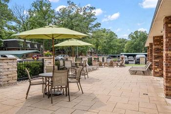a patio with umbrellas and chairs on it
